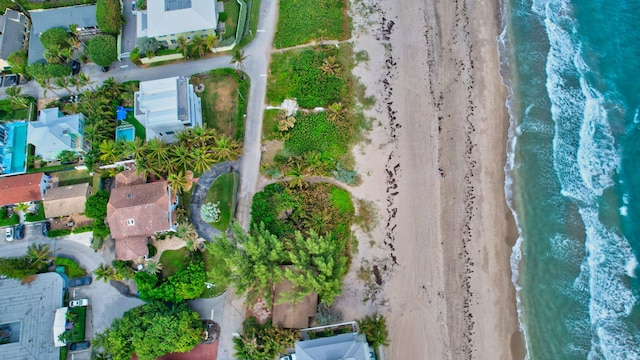 bird's eye view featuring a water view and a beach view