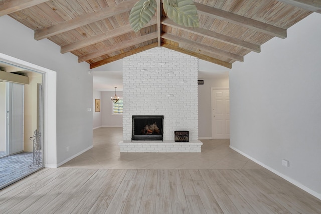 unfurnished living room featuring vaulted ceiling with beams, wooden ceiling, and a fireplace