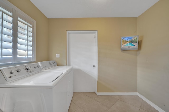 laundry room featuring light tile patterned flooring and washing machine and clothes dryer