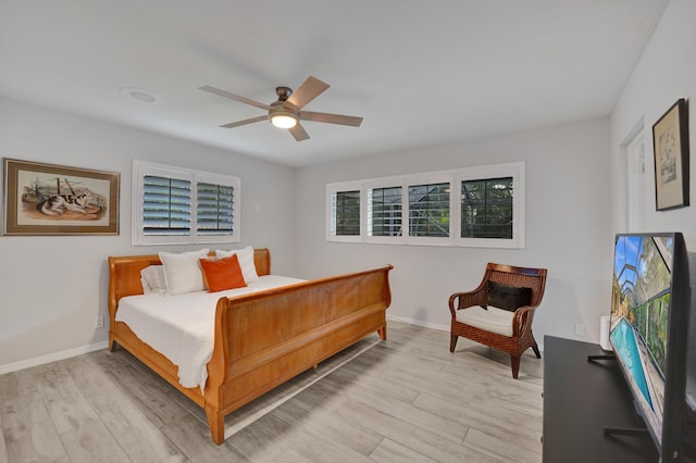 bedroom with light hardwood / wood-style flooring and ceiling fan