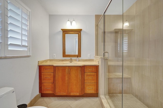 bathroom featuring toilet, vanity, and walk in shower