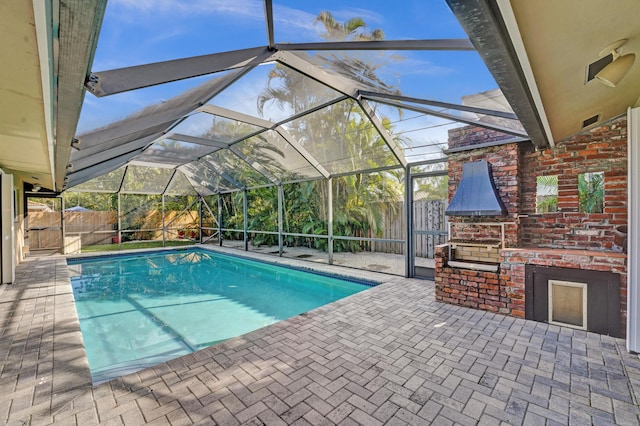 view of pool featuring a patio and glass enclosure