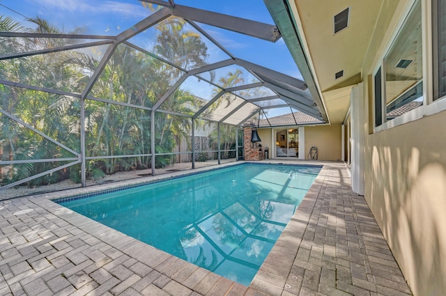 view of pool with a patio area and a lanai