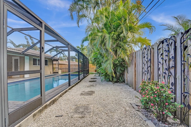 view of pool featuring glass enclosure