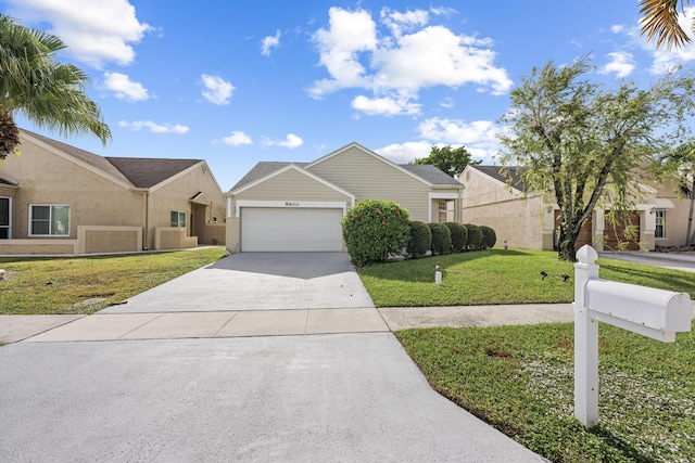 view of front of home with a garage and a front lawn