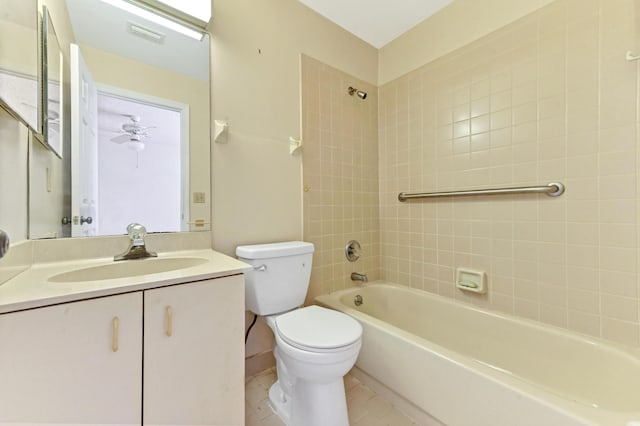 full bathroom featuring tile patterned floors, vanity, tiled shower / bath combo, ceiling fan, and toilet