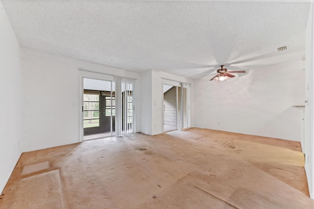 unfurnished room featuring ceiling fan and a textured ceiling