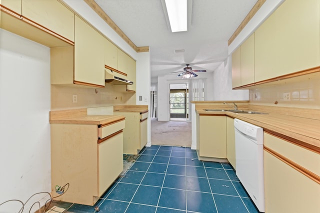 kitchen featuring ceiling fan, sink, cream cabinetry, dark tile patterned flooring, and dishwasher