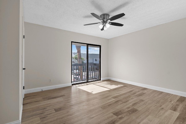 empty room featuring a textured ceiling, light hardwood / wood-style floors, and ceiling fan