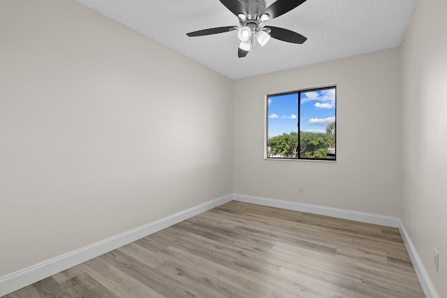 empty room featuring ceiling fan, light hardwood / wood-style floors, and a textured ceiling