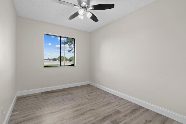 unfurnished room with ceiling fan, light hardwood / wood-style flooring, and a textured ceiling