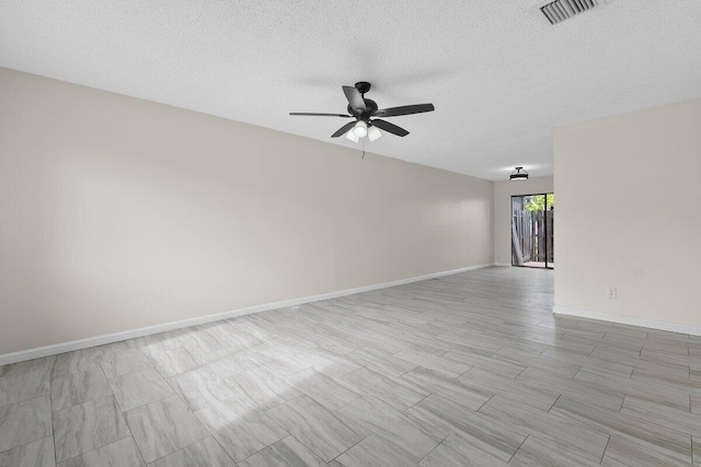 spare room with ceiling fan and a textured ceiling