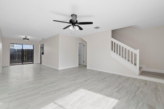 unfurnished living room with a textured ceiling and ceiling fan