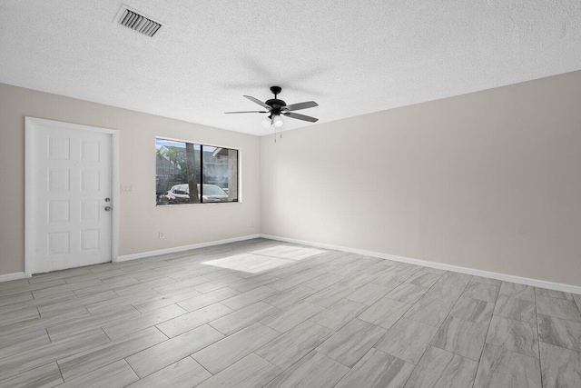 empty room featuring ceiling fan and a textured ceiling