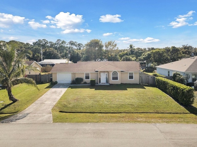 ranch-style home with a garage and a front yard