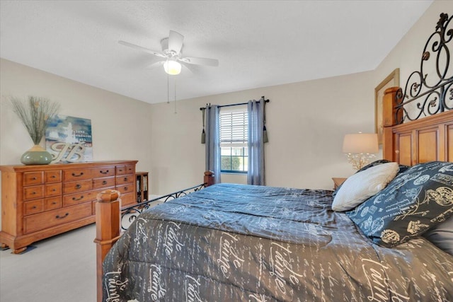 carpeted bedroom with a textured ceiling and ceiling fan