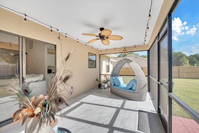 sunroom featuring ceiling fan