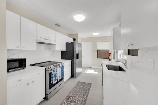 kitchen with tasteful backsplash, a textured ceiling, stainless steel appliances, sink, and white cabinets