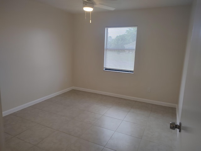 tiled empty room with ceiling fan