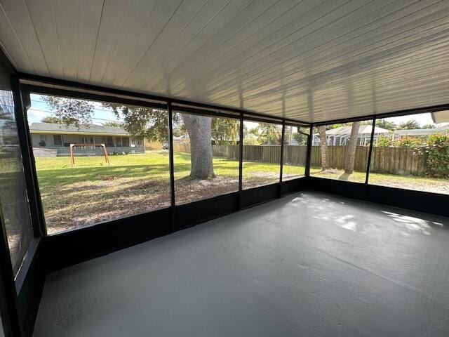 unfurnished sunroom with wood ceiling and a healthy amount of sunlight