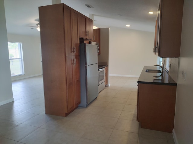 kitchen with ceiling fan, light tile patterned flooring, sink, and stainless steel appliances