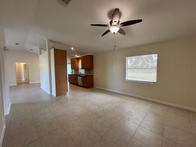 unfurnished living room featuring vaulted ceiling, ceiling fan, and light tile patterned flooring