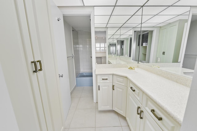 bathroom featuring tile patterned flooring, vanity, and tiled shower / bath combo