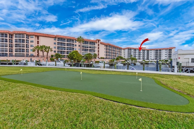 view of community featuring a lawn and a water view