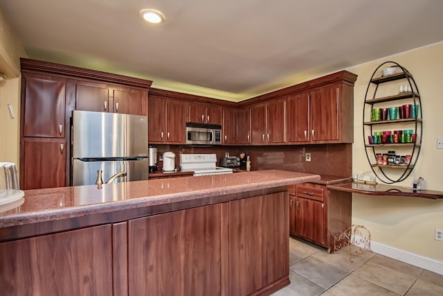 kitchen featuring light stone countertops, light tile patterned floors, backsplash, and stainless steel appliances