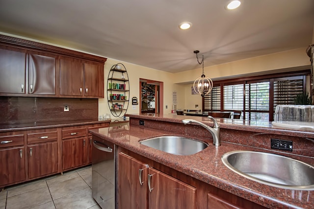 kitchen featuring light tile patterned flooring, pendant lighting, an inviting chandelier, and sink