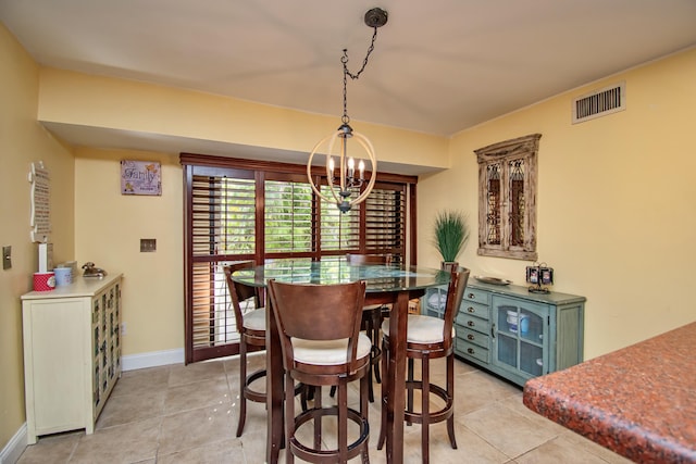 tiled dining area with an inviting chandelier