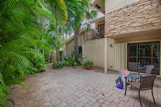 view of patio featuring a balcony