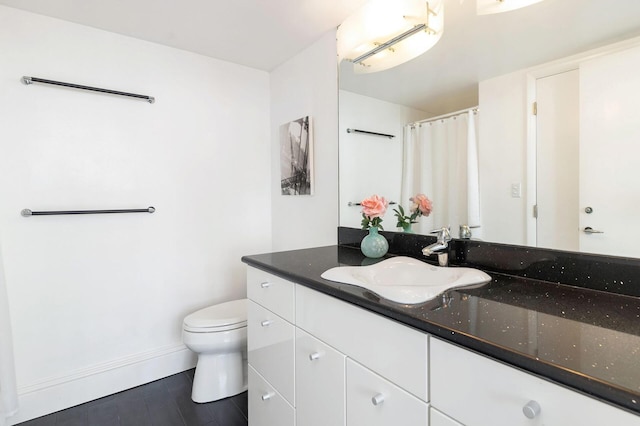 bathroom featuring vanity and toilet