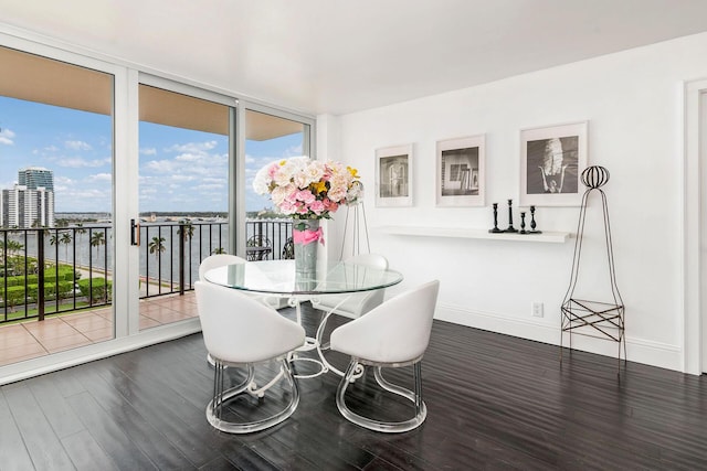 sunroom / solarium featuring a water view