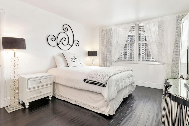 bedroom with dark wood-type flooring