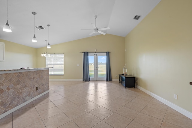 unfurnished room featuring ceiling fan, vaulted ceiling, light tile patterned flooring, and french doors