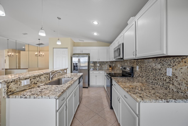 kitchen featuring appliances with stainless steel finishes, white cabinetry, decorative backsplash, sink, and hanging light fixtures