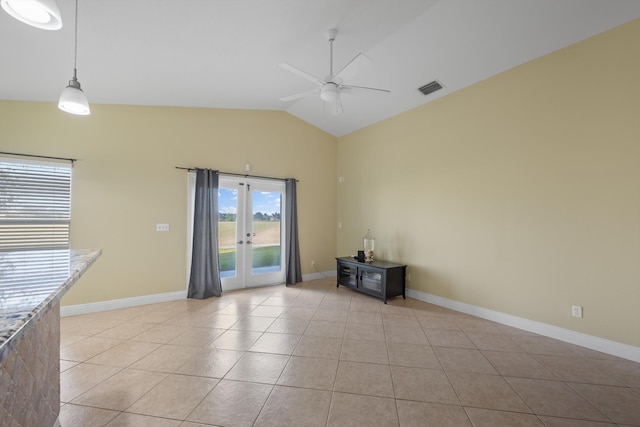 spare room with ceiling fan, light tile patterned flooring, lofted ceiling, and french doors