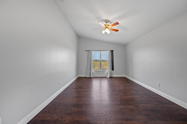 spare room with lofted ceiling, ceiling fan, and dark wood-type flooring