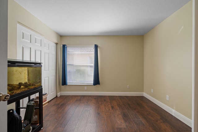 spare room with dark hardwood / wood-style flooring