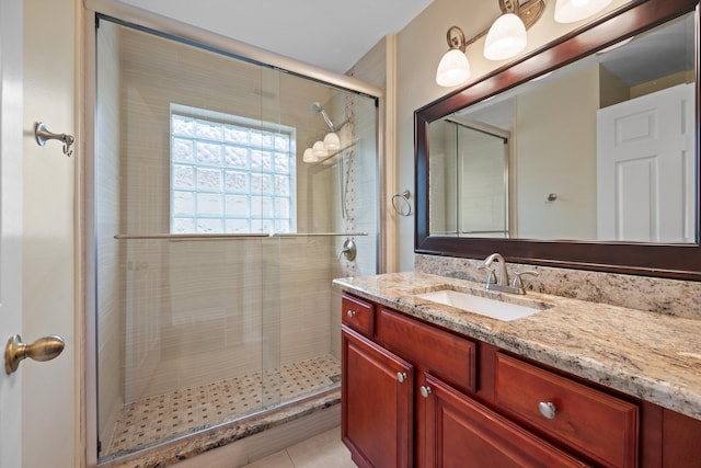 bathroom with tile patterned floors, an enclosed shower, and vanity