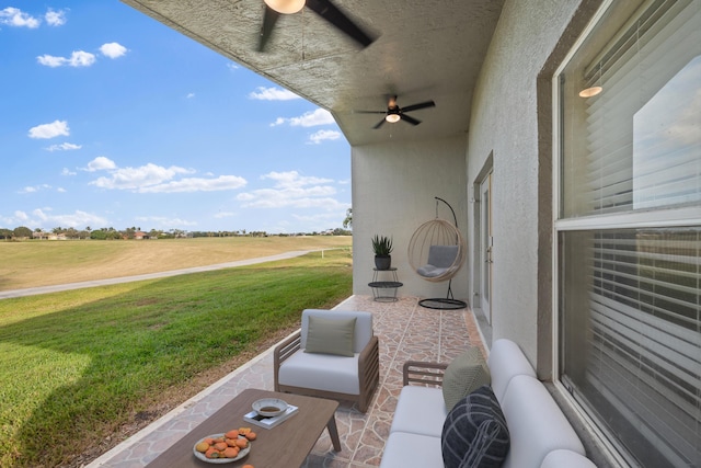 view of patio / terrace with ceiling fan, a rural view, and outdoor lounge area