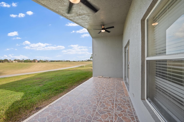 view of patio featuring ceiling fan and a rural view