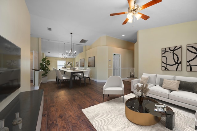 living room with dark wood-type flooring and ceiling fan with notable chandelier