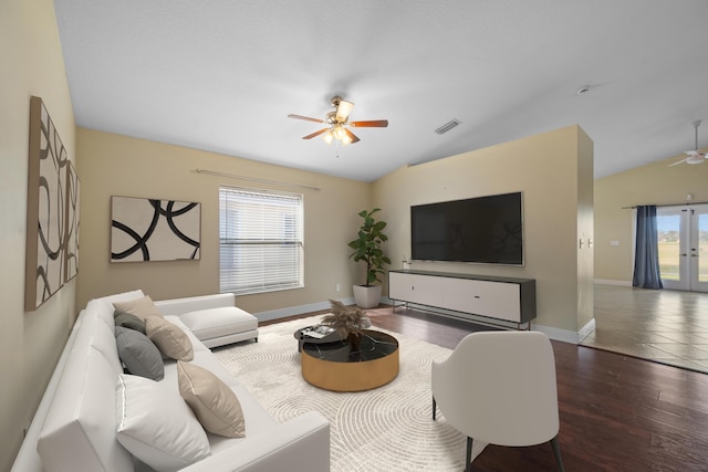 living room featuring ceiling fan, dark wood-type flooring, a healthy amount of sunlight, and vaulted ceiling