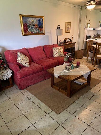 living room with light tile patterned floors and ceiling fan