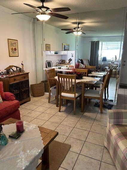 tiled dining room with ceiling fan