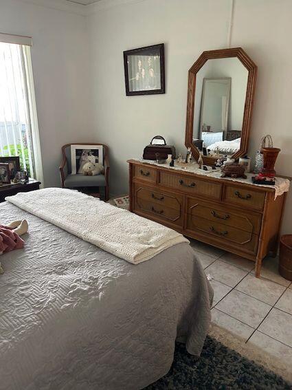 bedroom featuring light tile patterned floors