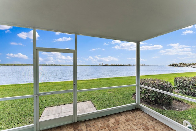 sunroom / solarium with a water view