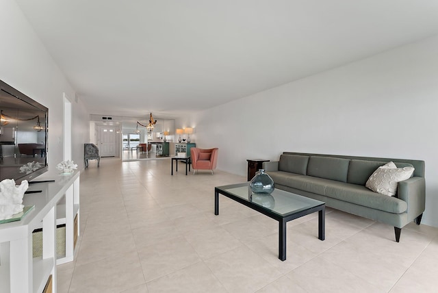 tiled living room with a chandelier